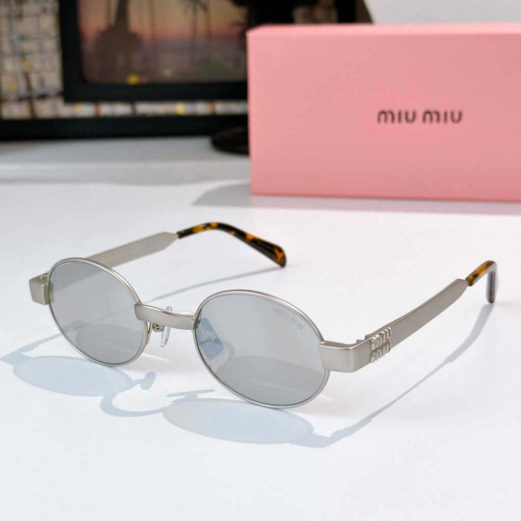MiuMiu sunglasses with gold-tone round frames, light gray lenses, tortoise-pattern temples