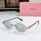 MiuMiu sunglasses with gold-tone round frames, light gray lenses, tortoise-pattern temples