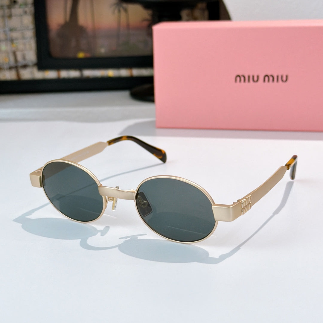 MiuMiu sunglasses with gold-tone round frames, deep teal lenses, tortoise-pattern temples