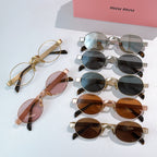MiuMiu sunglasses assortment with multiple gold-tone frames and tinted lenses, laid out