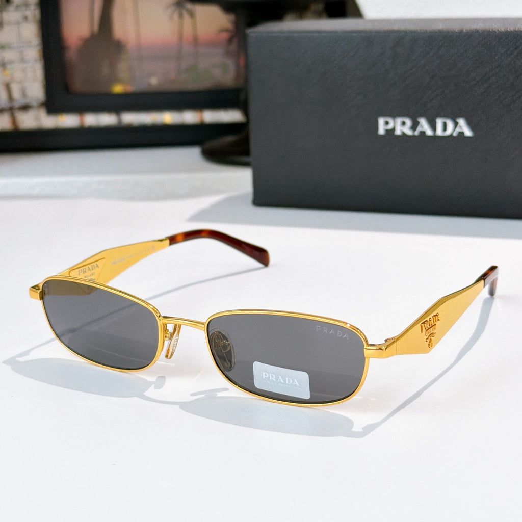 Prada sunglasses, gold frame with tortoiseshell arms, yellow-brown lenses