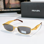 Prada sunglasses, gold frame with tortoiseshell arms, yellow-brown lenses