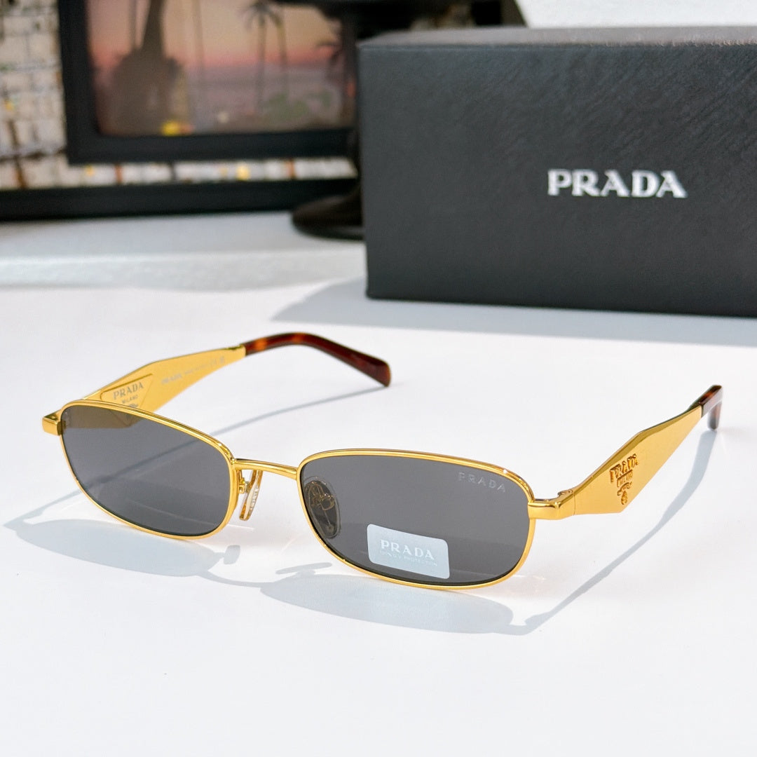Prada sunglasses, gold frame with tortoiseshell arms, yellow-brown lenses