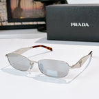 Prada sunglasses, silver frame with tortoiseshell temples, gray lenses