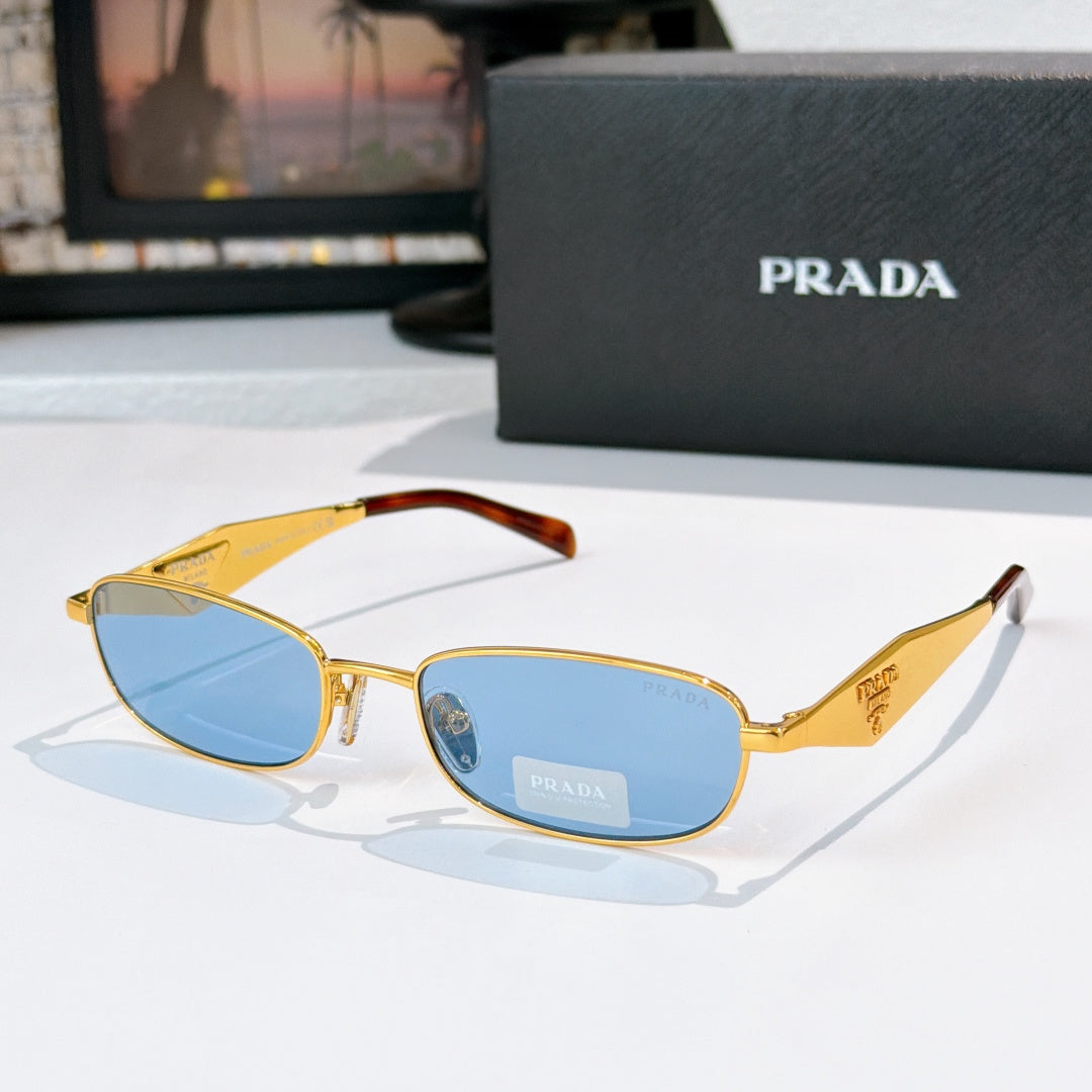 Prada sunglasses, gold frame, blue lenses, amber tortoiseshell temples