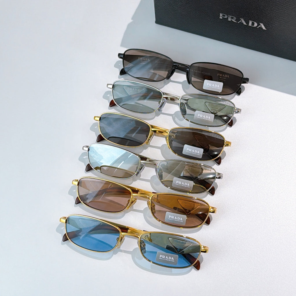 Prada sunglasses assortment, mixed frames and tinted lenses stacked together