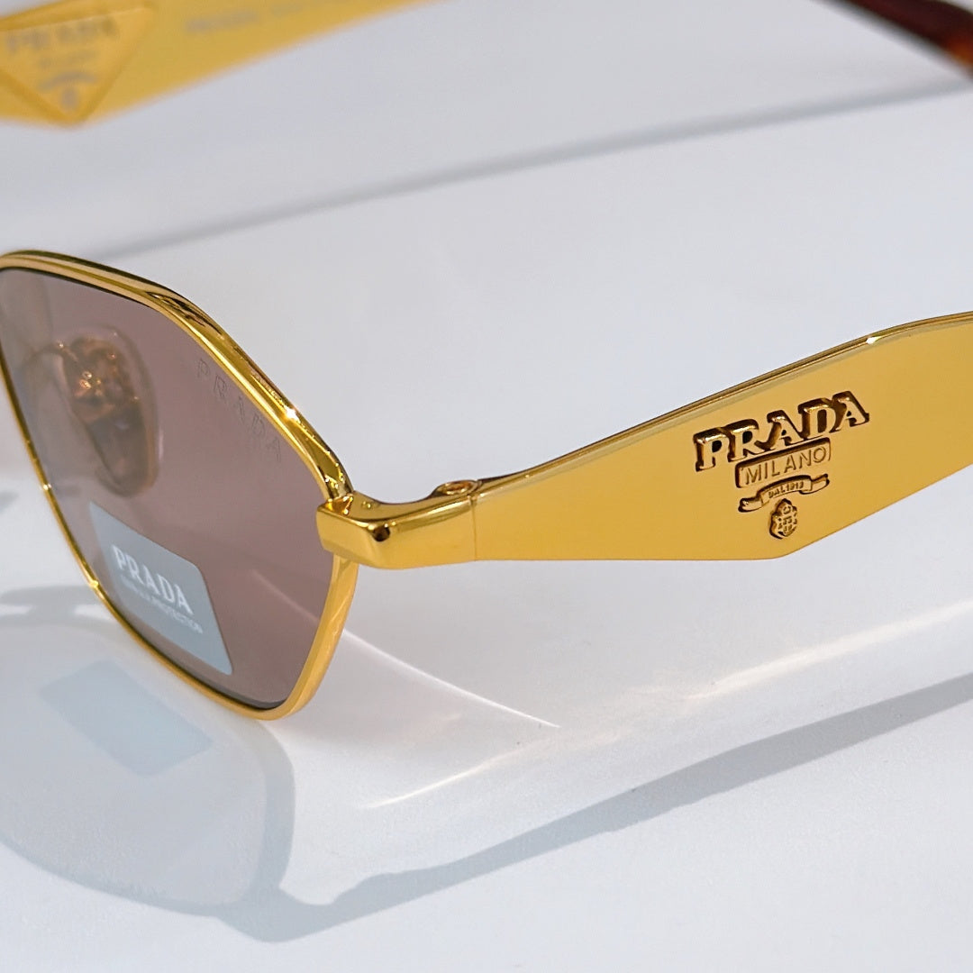 Prada glasses close-up: gold temple with logo, tinted lens, metal rim