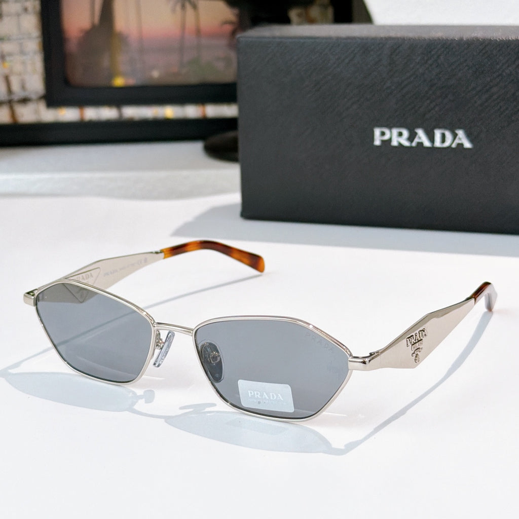 Prada glasses with silver frames, tortoiseshell arms, gray-blue lenses