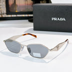 Prada glasses with silver frames, tortoiseshell arms, gray-blue lenses