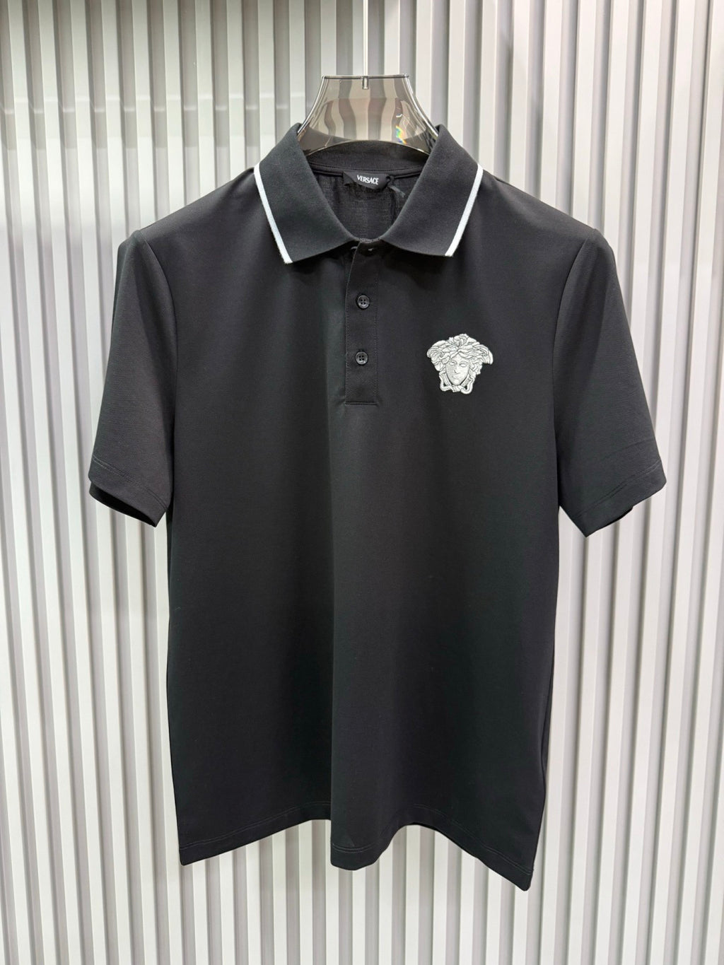Black Versace polo shirt with white contrast collar and Medusa crest