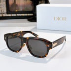 Dior sunglasses with dark tortoiseshell frames and dark lenses.