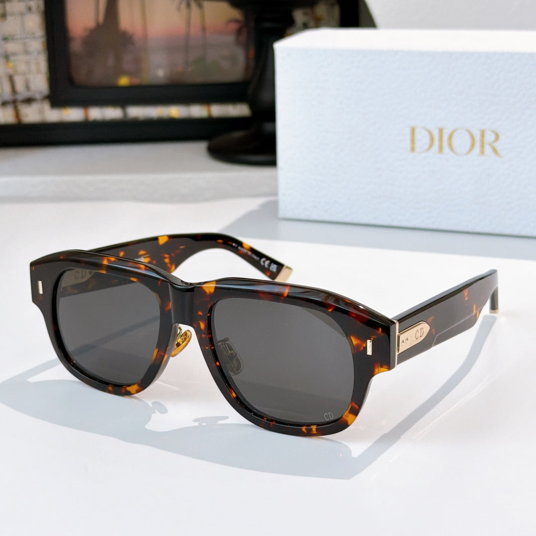 Dior sunglasses with dark tortoiseshell frames and dark lenses.