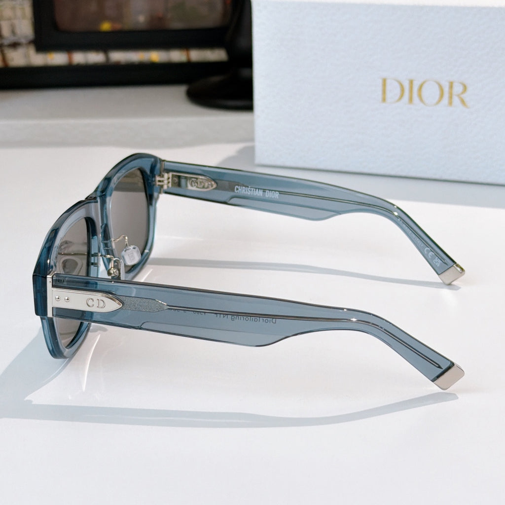 Dior sunglasses side view with blue frames and clear arms with logo details.