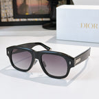 Dior sunglasses with black frames and dark gray gradient lenses.