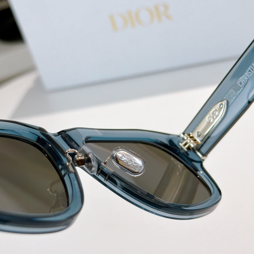 Dior sunglasses close-up of blue frame hinge and tinted lenses.