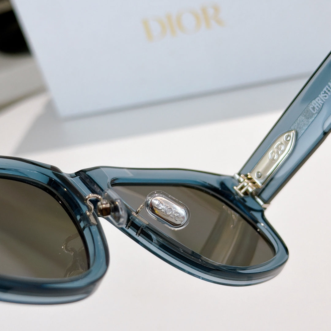Dior sunglasses close-up of blue frame hinge and tinted lenses.