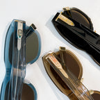 Dior sunglasses close-up of blue and gold frames with dark lenses.