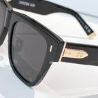 Dior sunglasses close-up, black frame with gold-tone details