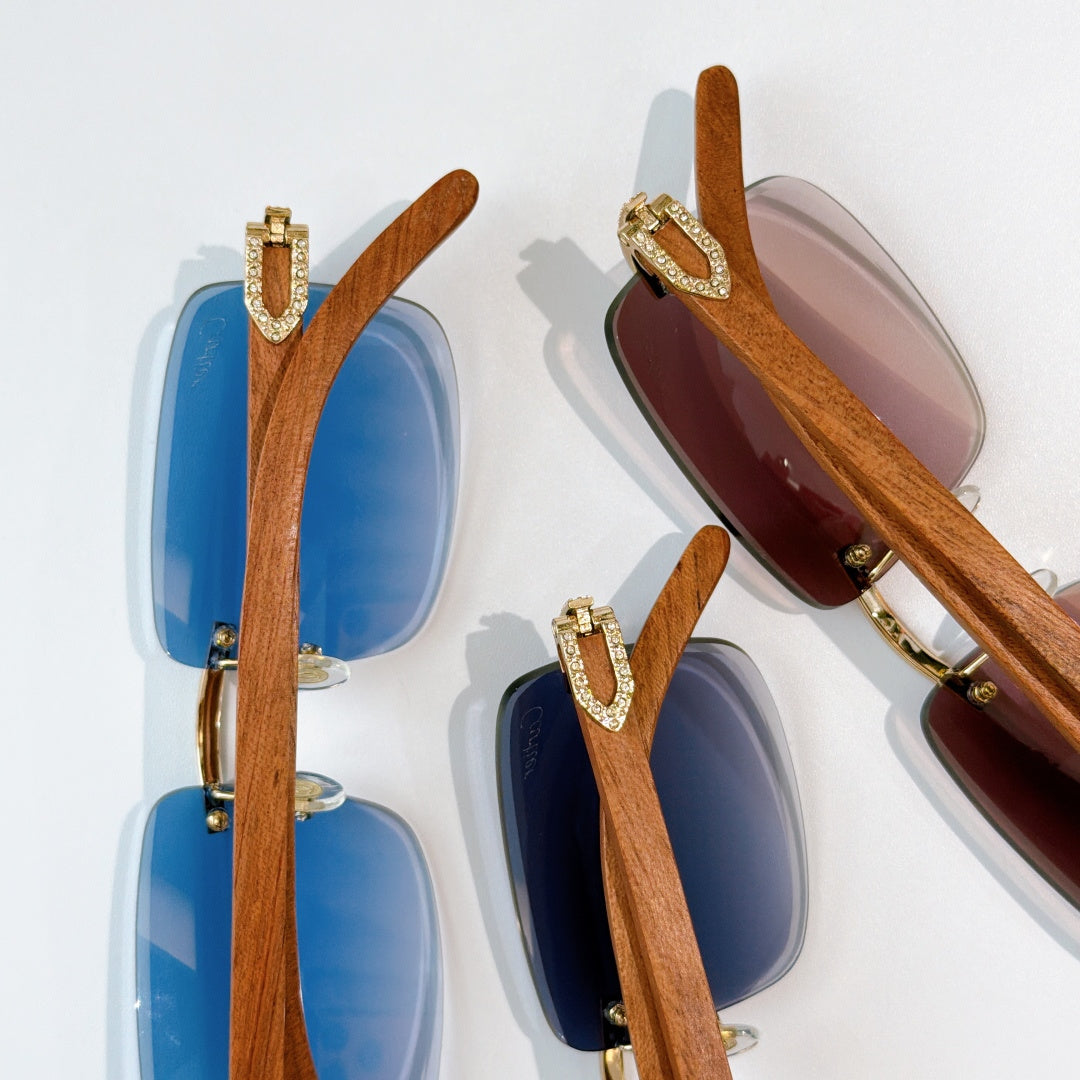 Pair of square sunglasses with wood-look brown arms; one blue, one dark brown tinted lens