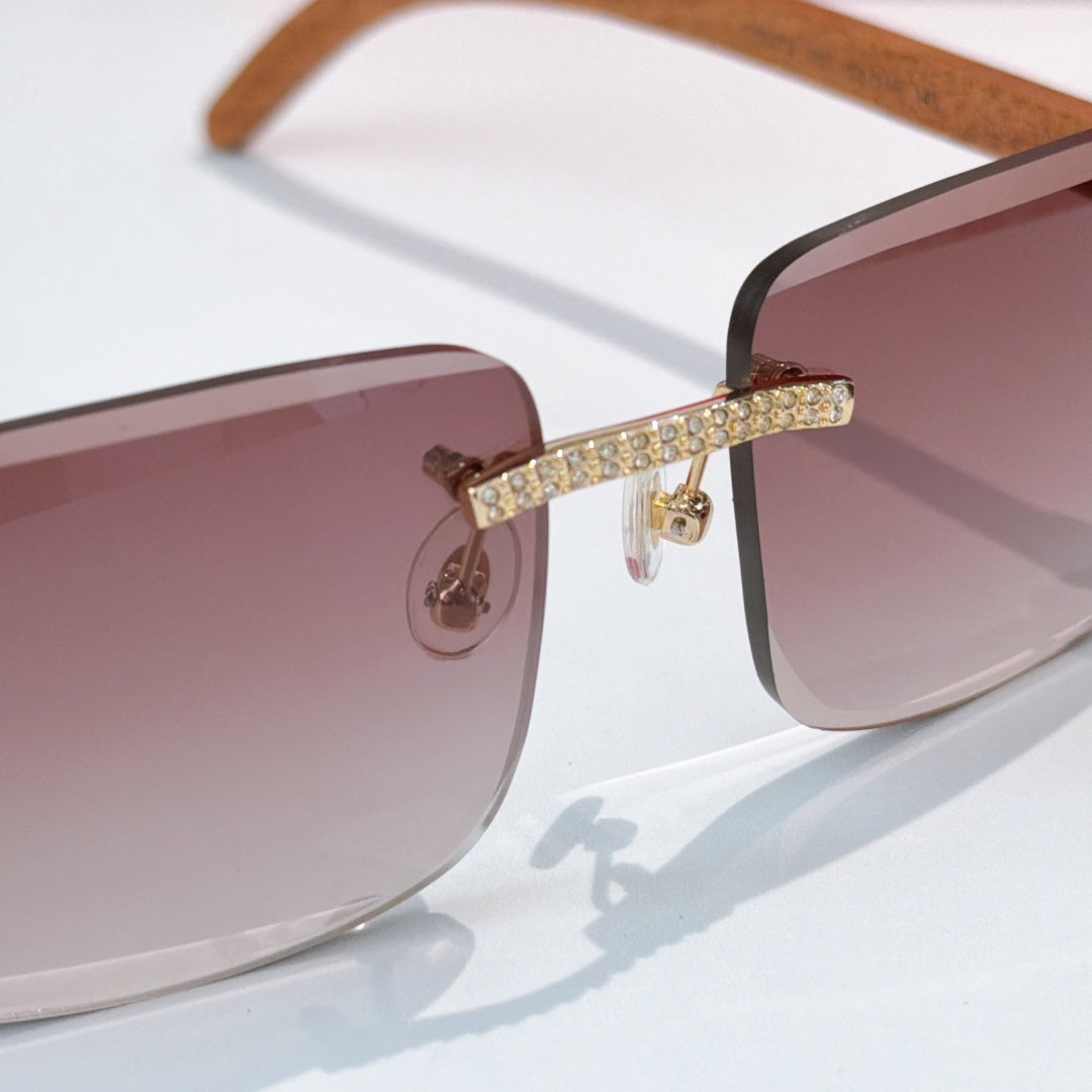 Side view of square sunglasses with mauve tinted lens and gold rhinestone bar across frame