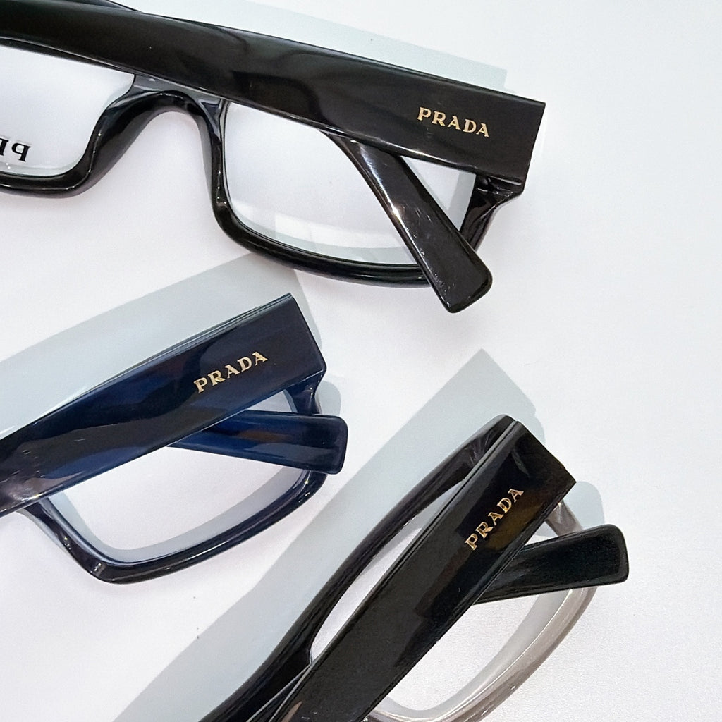 Prada eyeglasses close-up assortment with black and blue rectangular frames and clear lenses