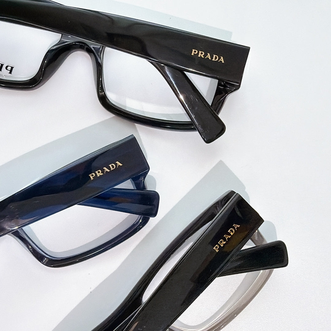 Prada eyeglasses close-up assortment with black and blue rectangular frames and clear lenses