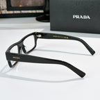 Prada eyeglasses side view with matte black rectangular frame and clear lenses