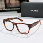 Prada eyeglasses with tortoiseshell rectangular frames and logo temples, clear lenses