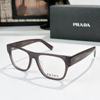 Prada eyeglasses with brown translucent rectangular frames and logo temples, clear lenses
