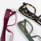 Prada eyeglass frames: red, tortoiseshell, and green