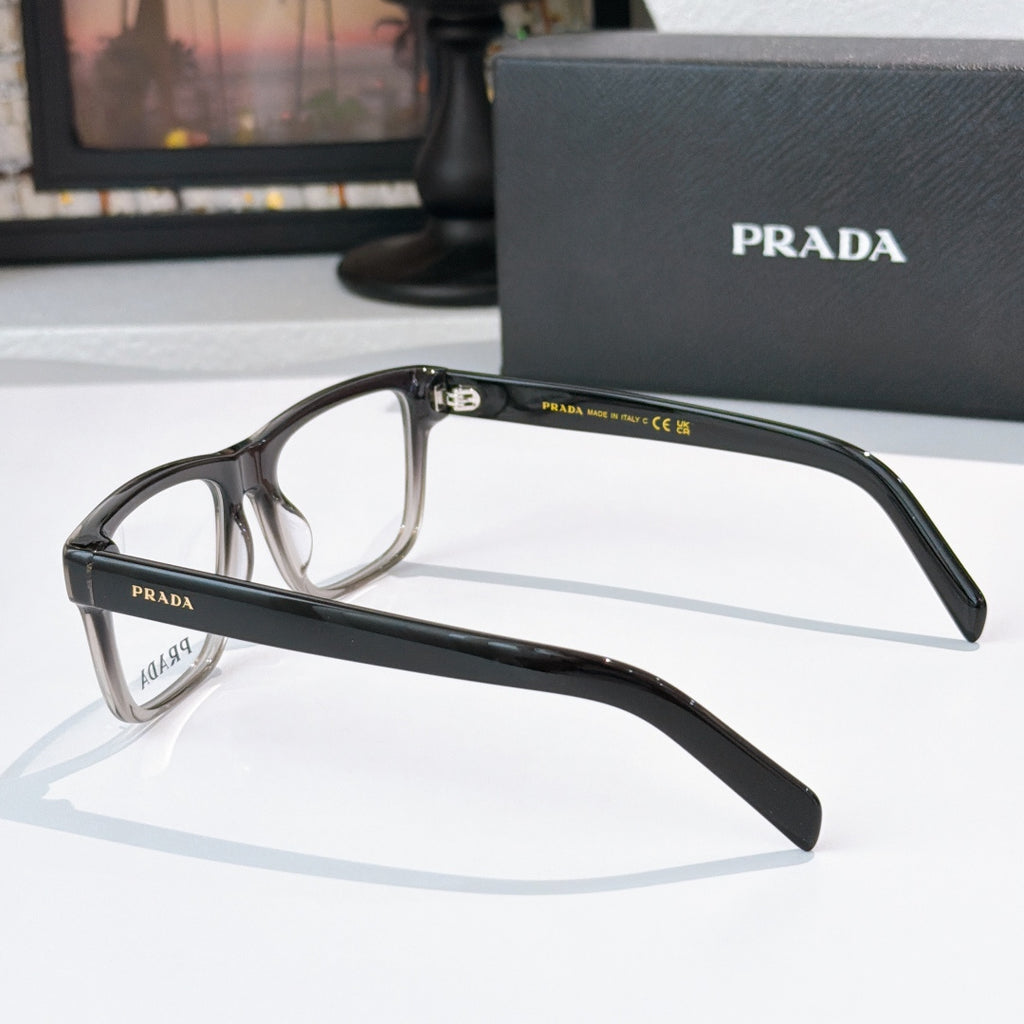 Prada black eyeglasses, side profile with temple logo and clear lenses.
