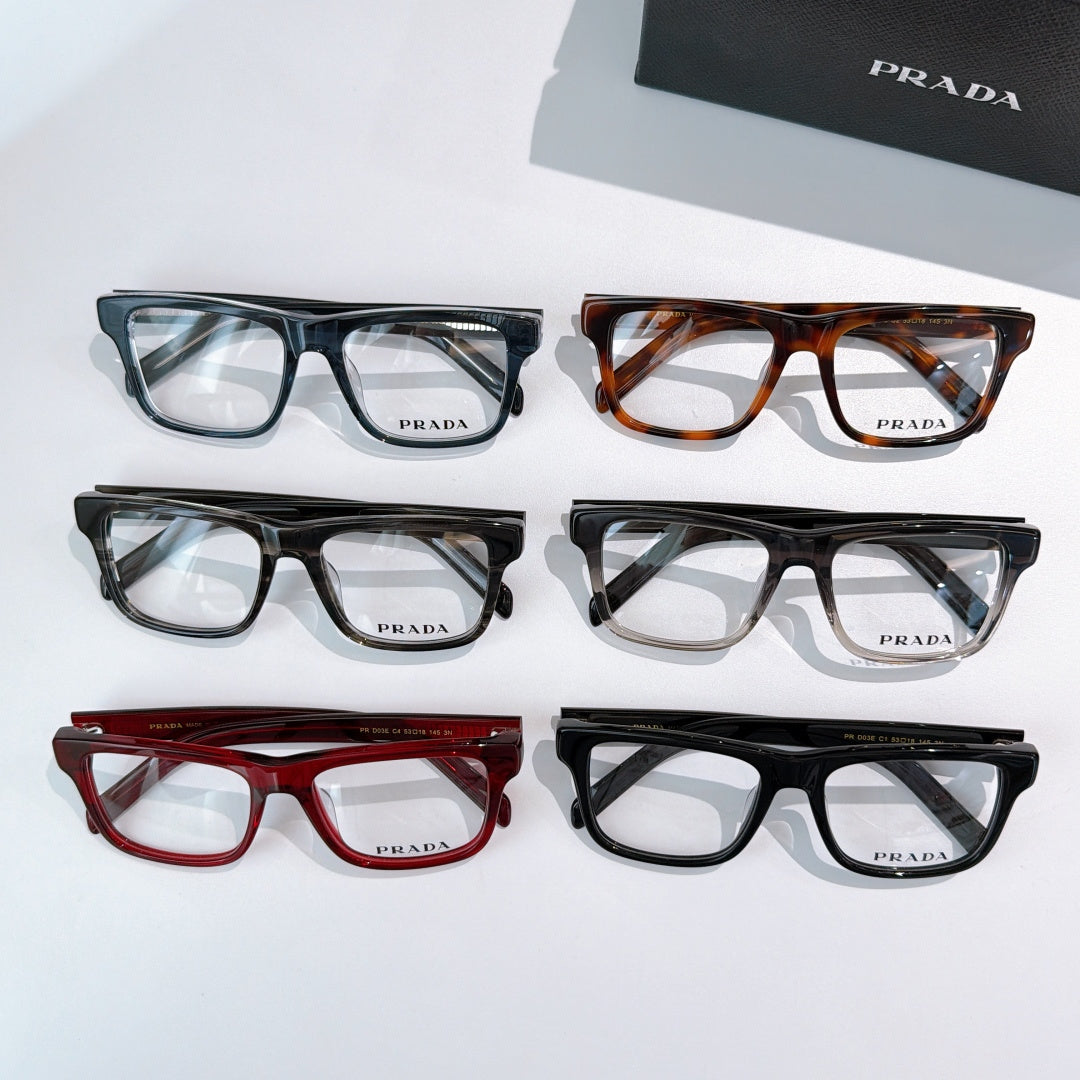 Prada eyeglasses assortment: blue, tortoiseshell, red, and black rectangular frames.