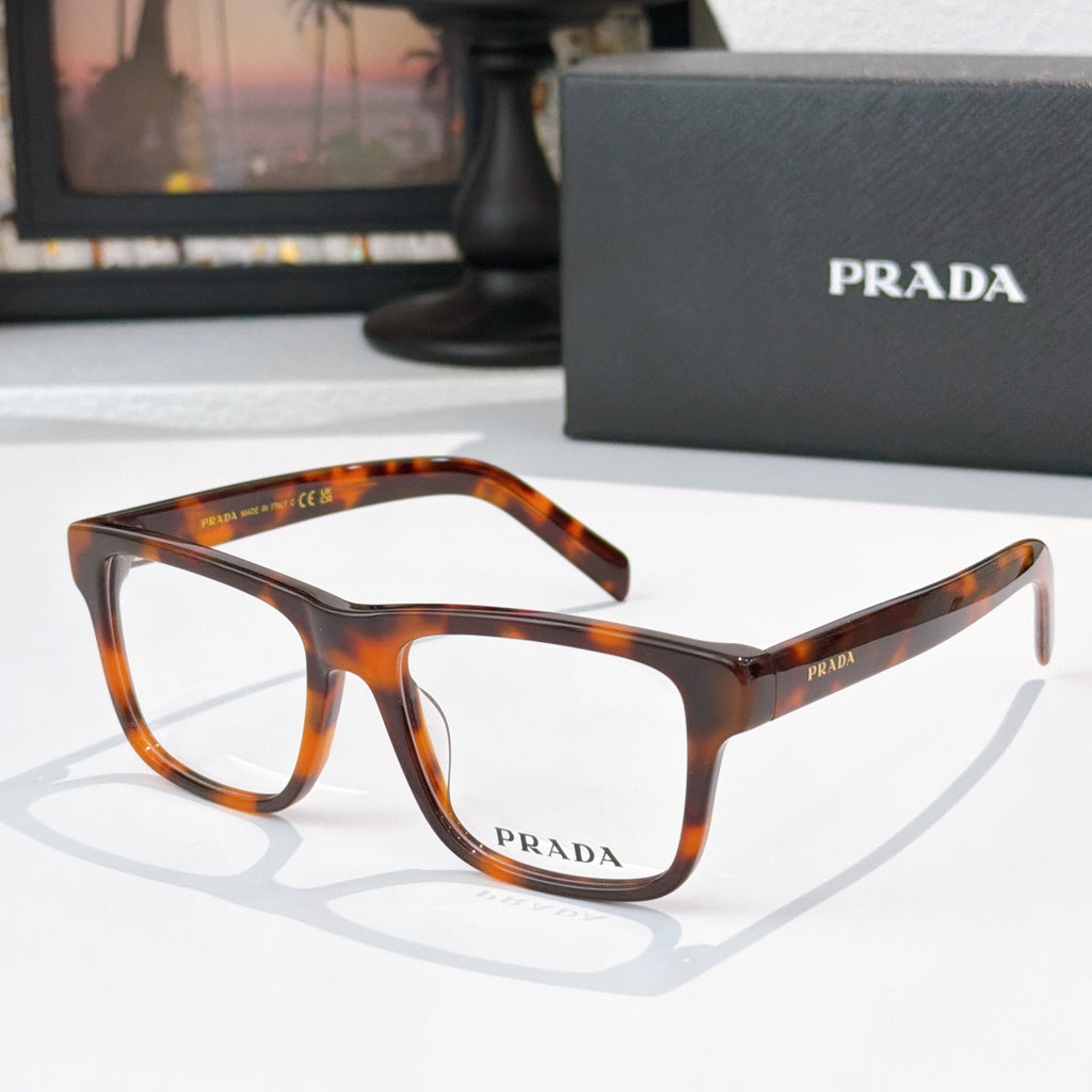 Prada tortoiseshell eyeglasses with rectangular frames and clear lenses.