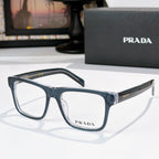 Prada blue-gray eyeglasses with rectangular frames and clear lenses.