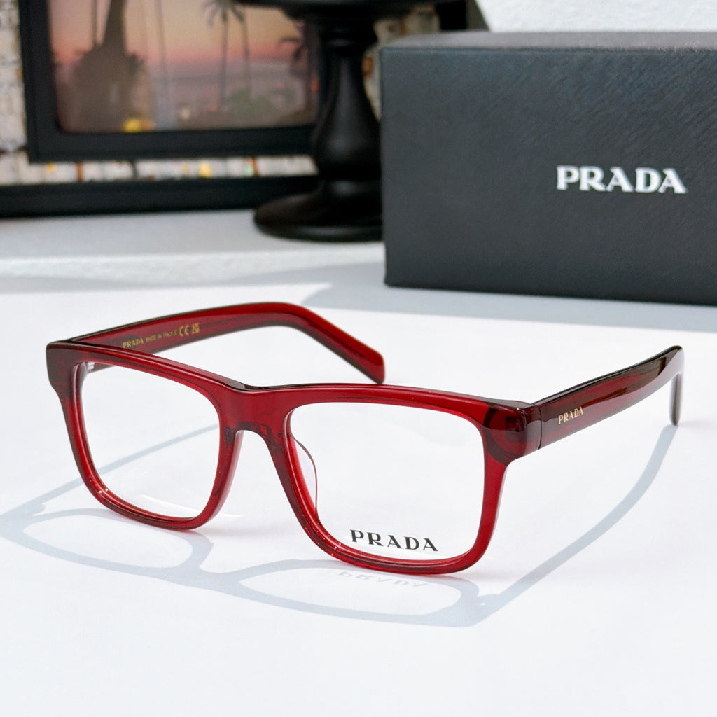 Prada red eyeglasses with rectangular frames and clear lenses.