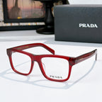 Prada red eyeglasses with rectangular frames and clear lenses.
