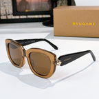 Sunglasses with black frames and amber tinted lenses, gold logo detail