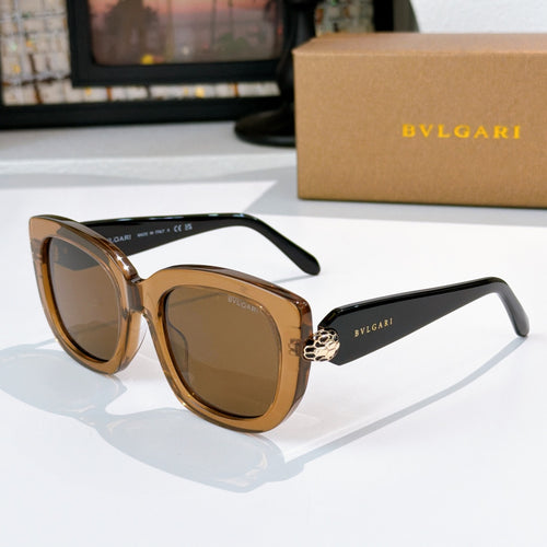 Sunglasses with black frames and amber tinted lenses, gold logo detail