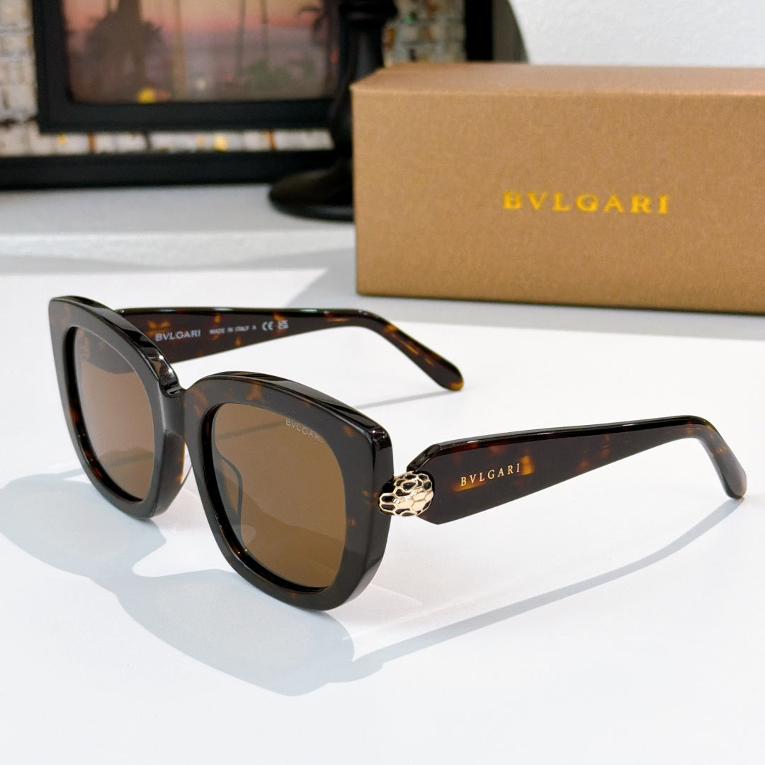 Sunglasses with dark tortoiseshell frames and brown tinted lenses, gold logo detail