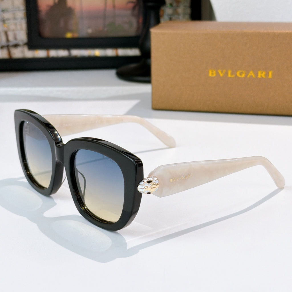 Sunglasses with black frames, pale cream temples, and blue tinted lenses