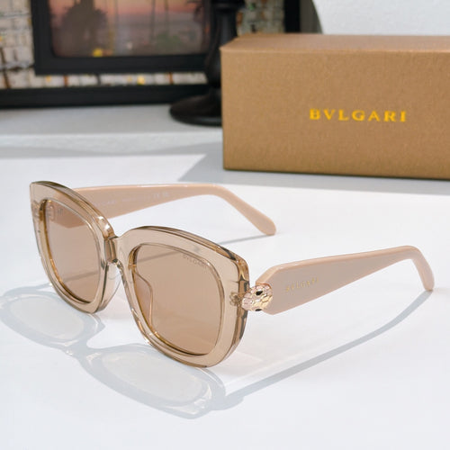 Sunglasses with light tan frames and brown tinted lenses, gold logo detail