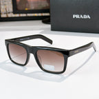 Black square eyeglasses with brown tinted lenses and glossy angular frame