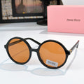 MiuMiu glasses with black round frames and orange-tinted lenses
