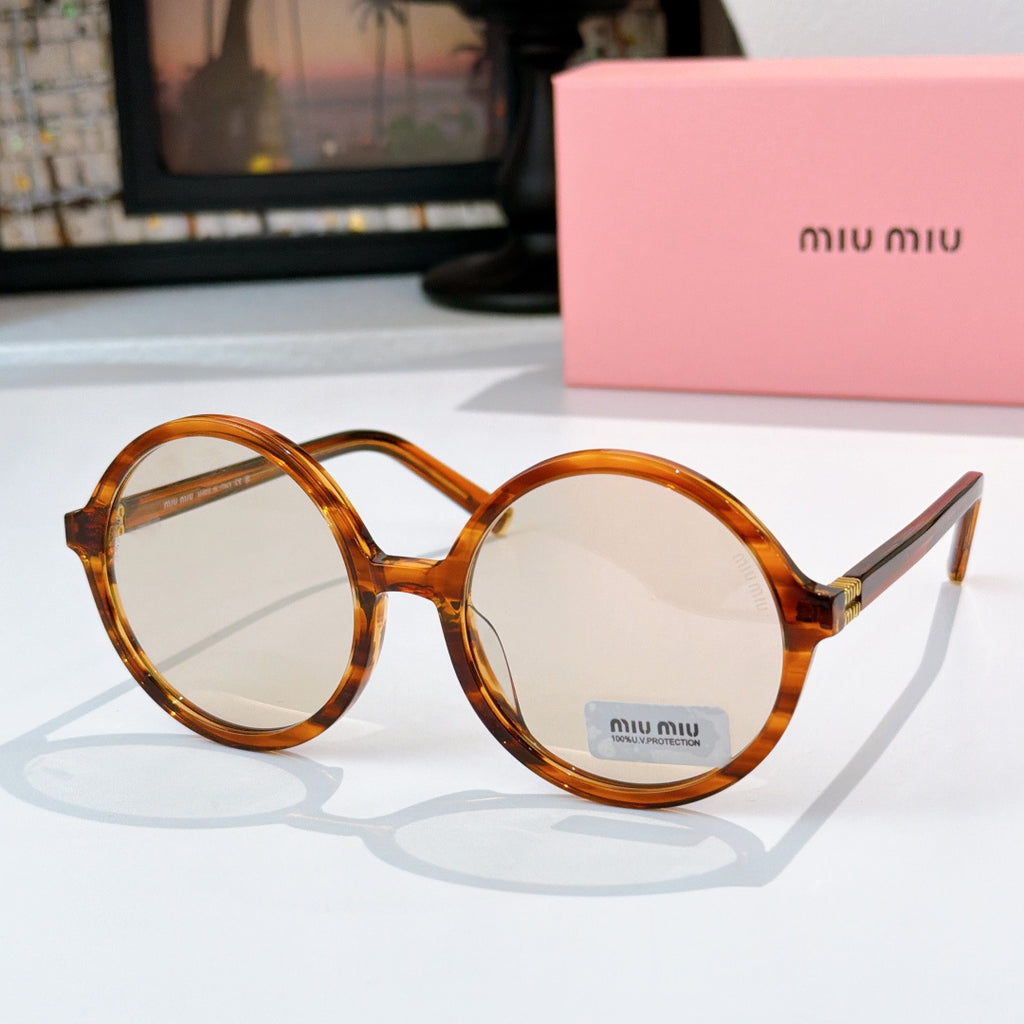 MiuMiu glasses with amber round frames and clear-to-light tinted lenses