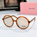 MiuMiu glasses with amber round frames and clear-to-light tinted lenses
