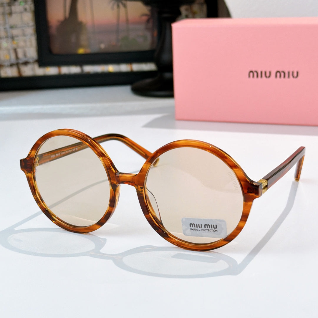 MiuMiu glasses with amber round frames and clear-to-light tinted lenses