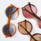 MiuMiu round eyeglass frames in amber, blue, and pink lens tints (set view)