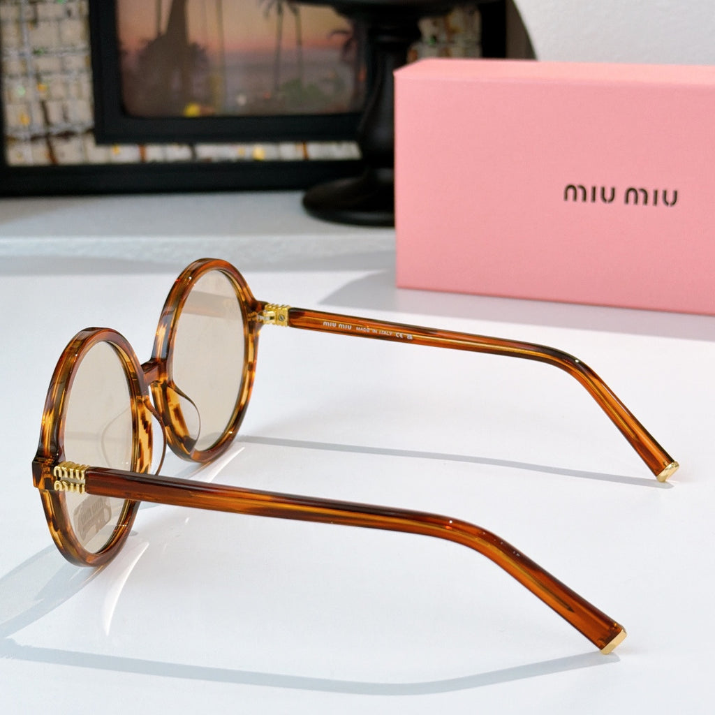 MiuMiu glasses in amber round frames, side view with gold-tone accents