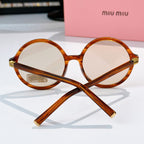 MiuMiu glasses with amber round frames and gold-tone hinges, front view