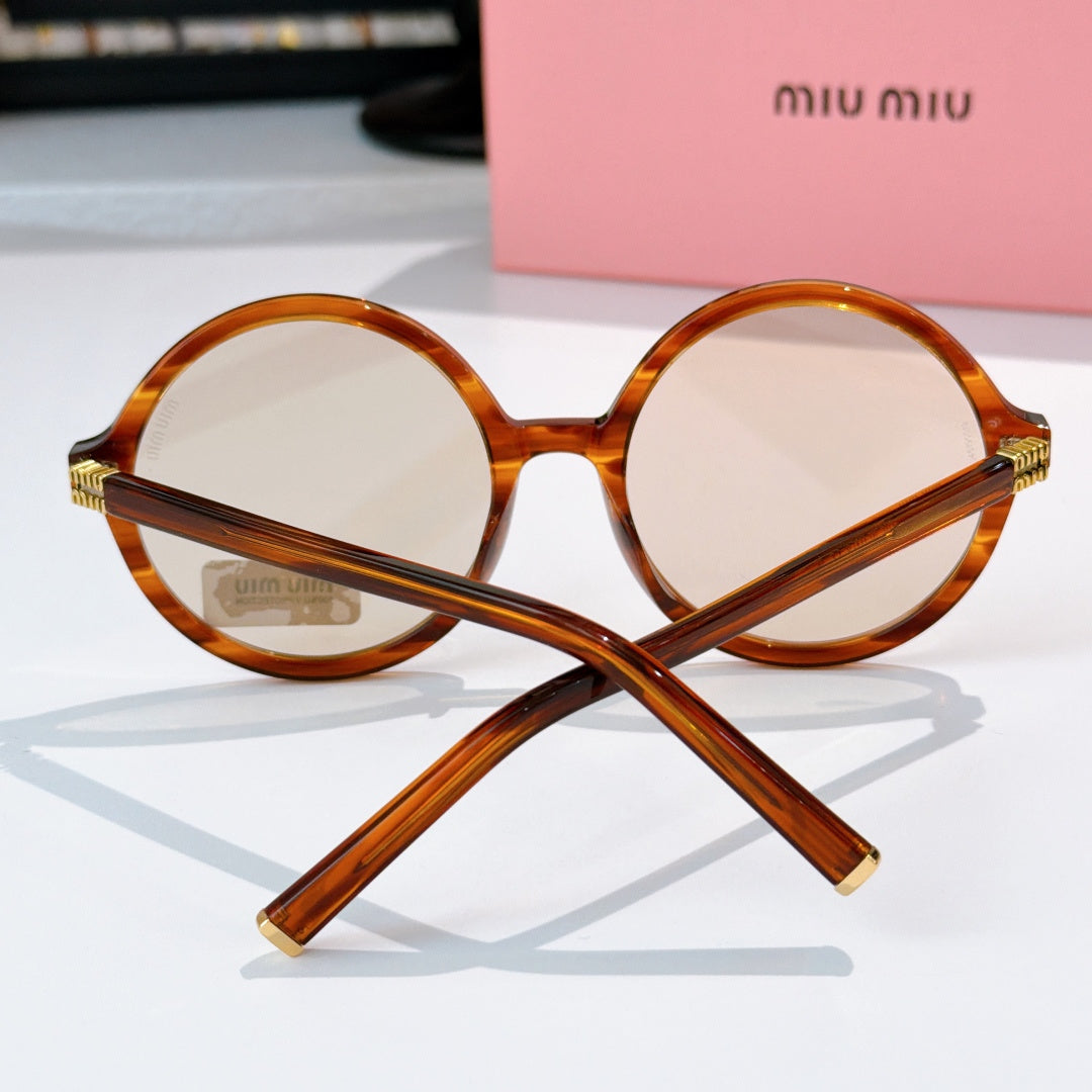 MiuMiu glasses with amber round frames and gold-tone hinges, front view